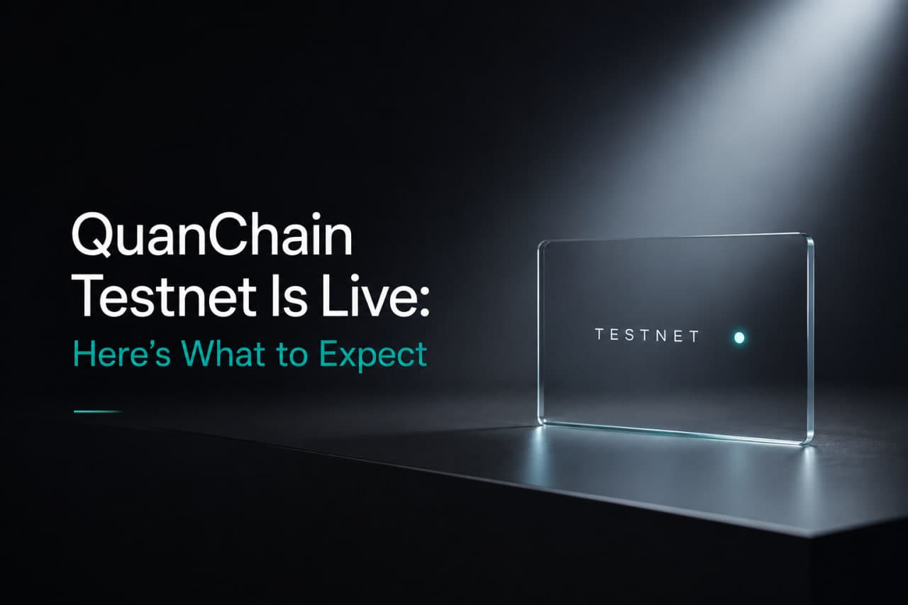 Frosted glass rectangular card on a dark surface under a spotlight, displaying the word "TESTNET" with a small teal dot, heading "QuanChain Testnet Is Live: Here's What to Expect"